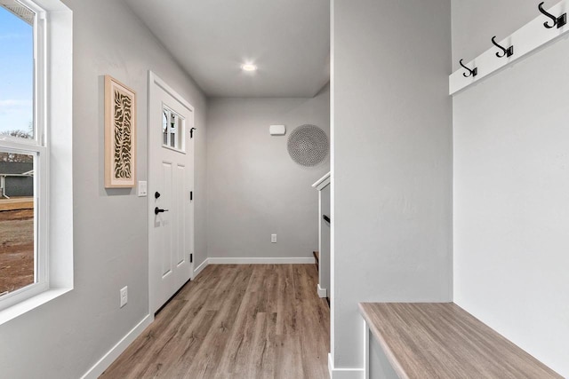 mudroom featuring light wood-style flooring and baseboards