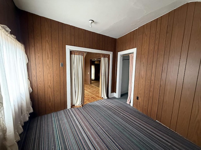 spare room with wood walls