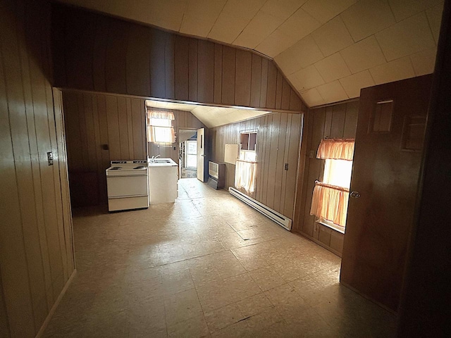 corridor featuring a baseboard radiator, vaulted ceiling, wood walls, light floors, and a sink