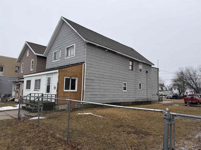 view of property exterior featuring entry steps and fence