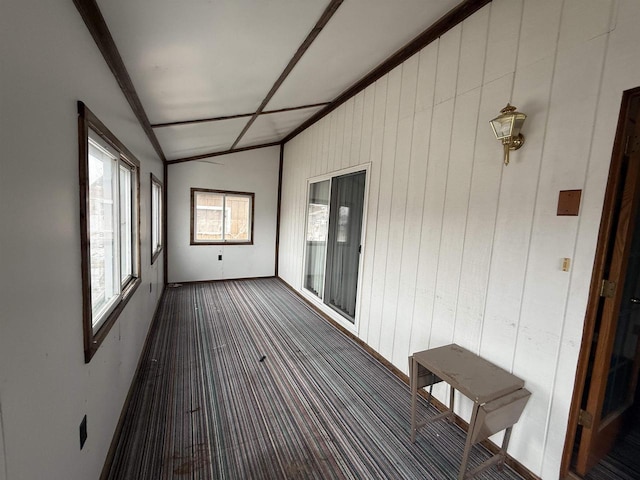 unfurnished sunroom featuring lofted ceiling