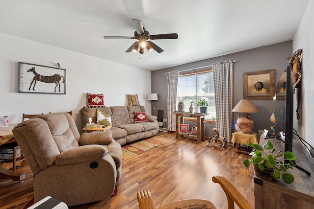 living room with ceiling fan and wood finished floors