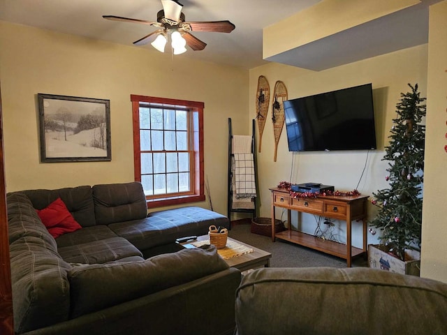 carpeted living area with a ceiling fan