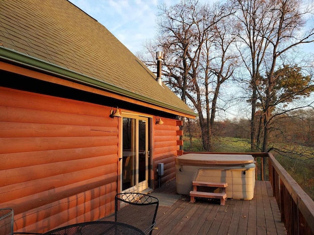 wooden terrace featuring a hot tub