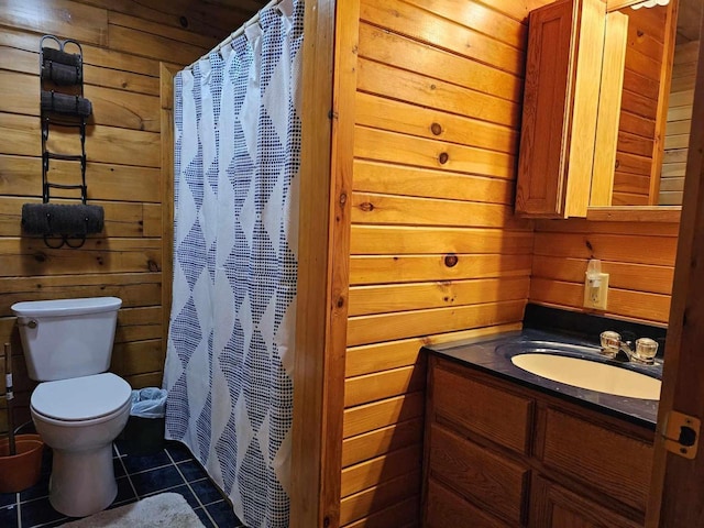 full bathroom featuring toilet, wood walls, tile patterned floors, vanity, and a shower with curtain