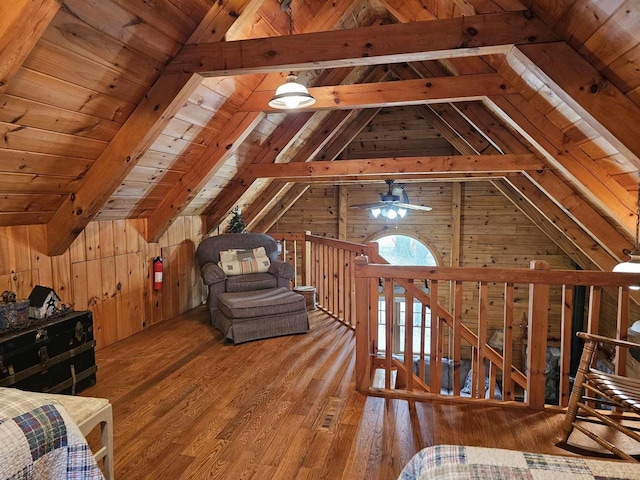 bedroom featuring vaulted ceiling with beams, wood ceiling, wooden walls, and wood finished floors