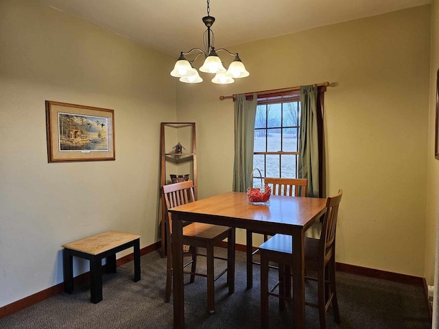 dining area with dark colored carpet, baseboards, and an inviting chandelier