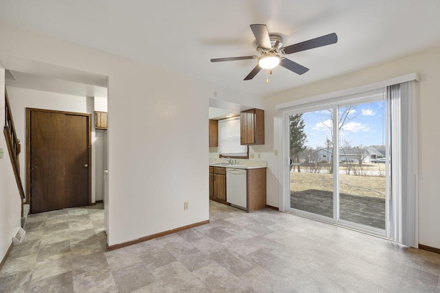 interior space featuring baseboards, visible vents, ceiling fan, and a sink