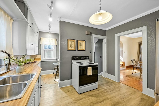 kitchen featuring a sink, wooden counters, electric range oven, and light wood finished floors