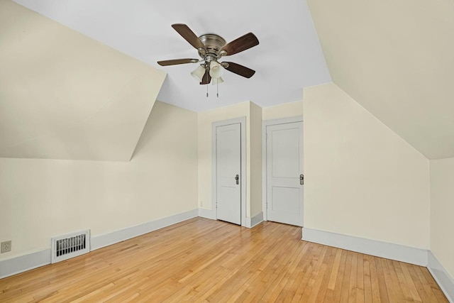 bonus room with visible vents, ceiling fan, baseboards, lofted ceiling, and hardwood / wood-style flooring