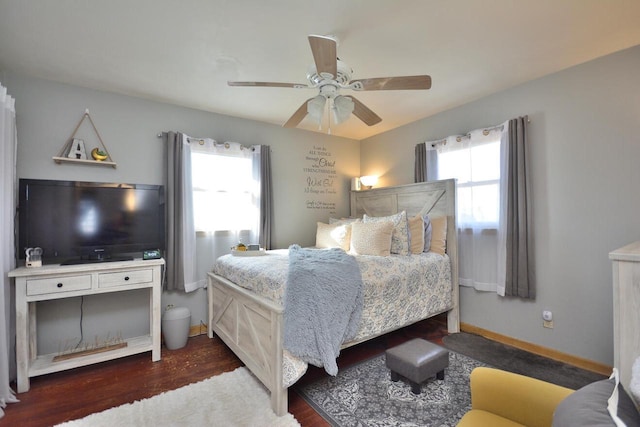 bedroom featuring ceiling fan, baseboards, and wood finished floors