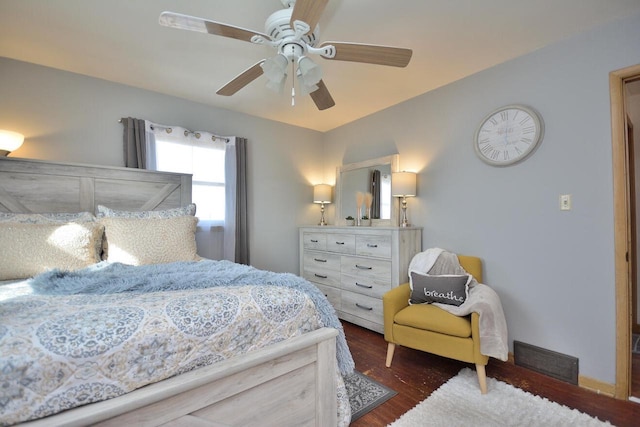 bedroom featuring visible vents, dark wood finished floors, and ceiling fan