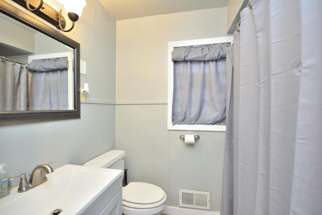 full bathroom with visible vents, vanity, and toilet