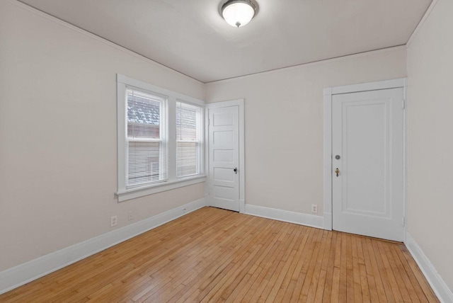 empty room with light wood finished floors and baseboards