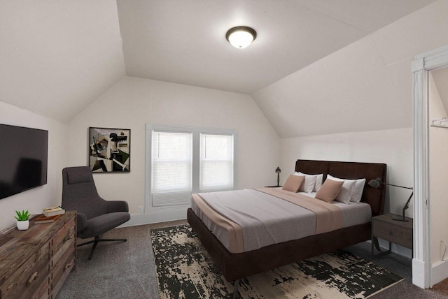 bedroom with carpet floors and vaulted ceiling