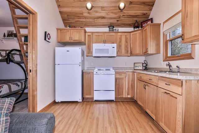 kitchen with lofted ceiling, white appliances, light brown cabinets, and a sink