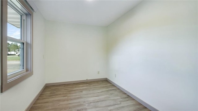 spare room with light wood-style flooring and baseboards