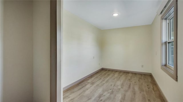 empty room featuring light wood-style floors and baseboards