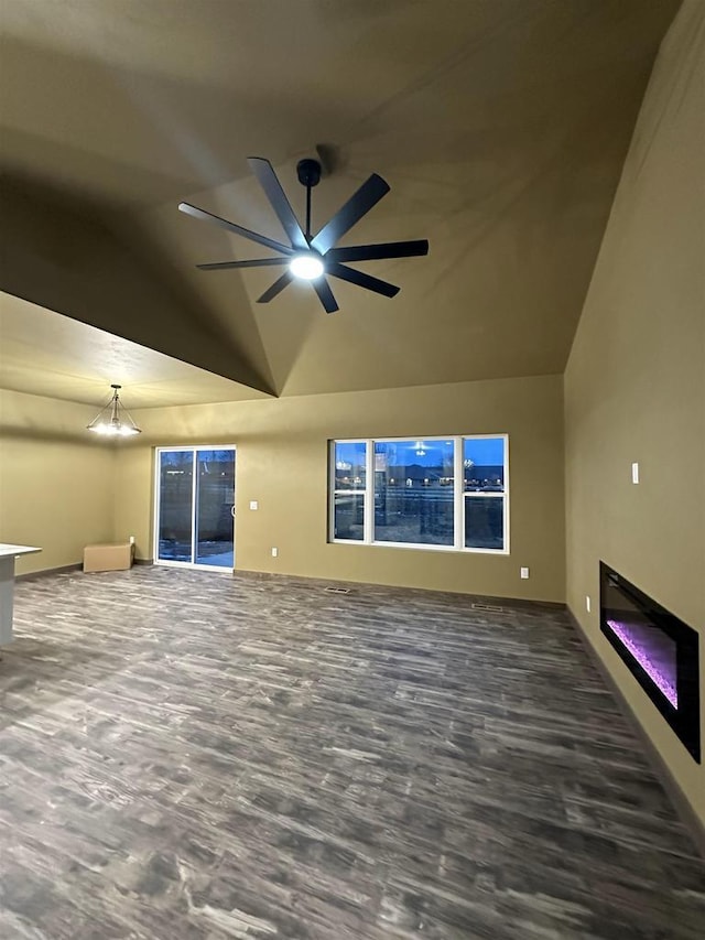 unfurnished living room featuring lofted ceiling, ceiling fan, and a glass covered fireplace