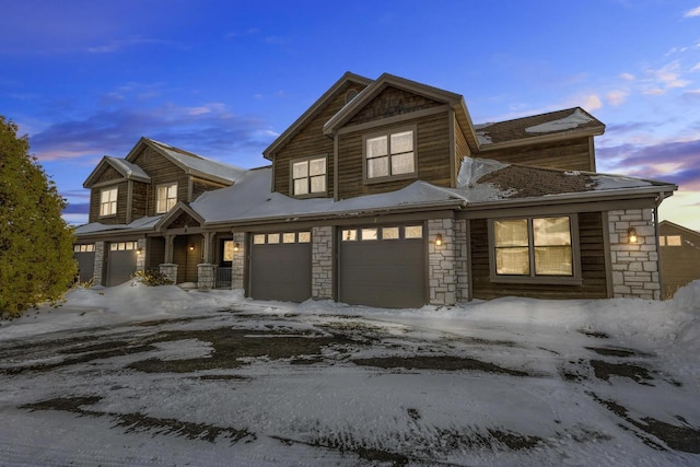 view of front of house featuring stone siding and an attached garage