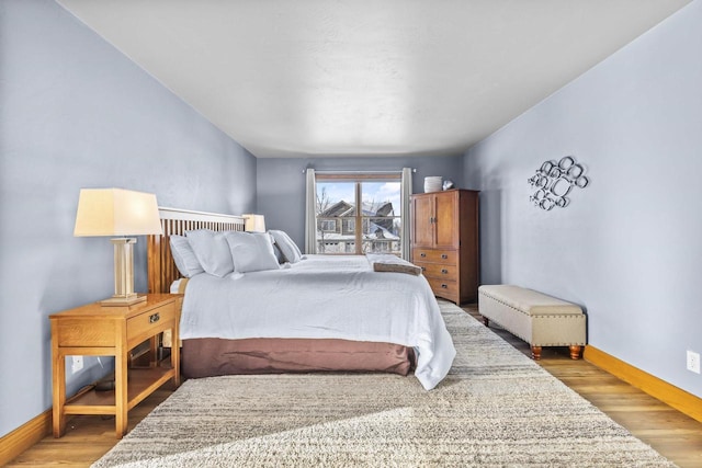 bedroom featuring wood finished floors and baseboards