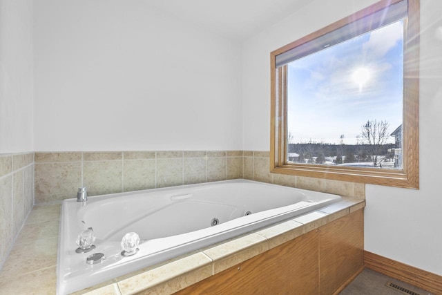 bathroom featuring a jetted tub, visible vents, and baseboards