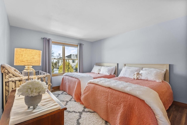 bedroom featuring wood finished floors and baseboards