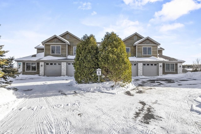 view of front of house with stone siding and an attached garage