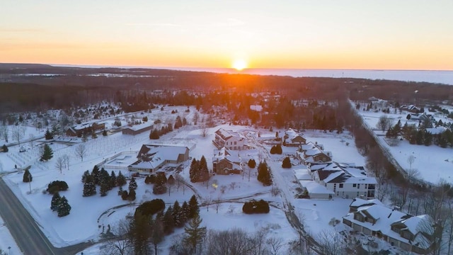 snowy aerial view with a residential view