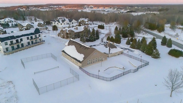 snowy aerial view featuring a residential view