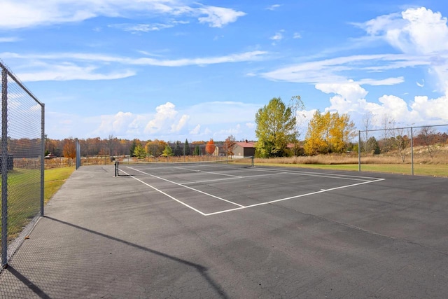 view of tennis court featuring fence