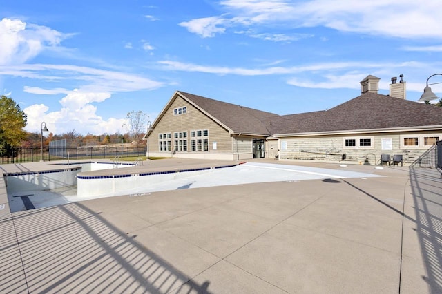 pool with fence and a patio