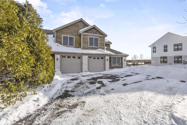 view of front of home featuring an attached garage and stone siding