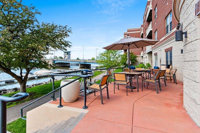 view of patio featuring outdoor dining space and a water view