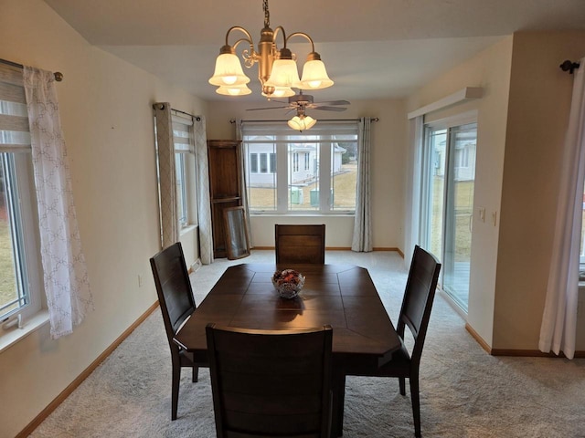 dining space with a notable chandelier, baseboards, and carpet flooring