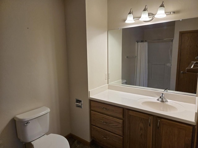 bathroom featuring curtained shower, vanity, and toilet