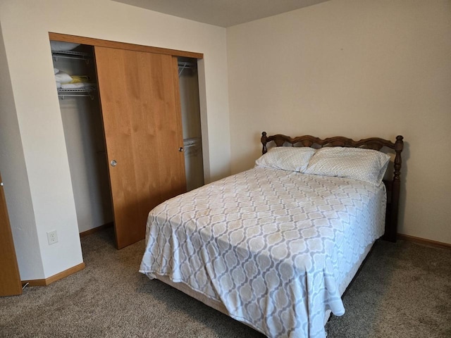 bedroom with carpet floors, a closet, and baseboards