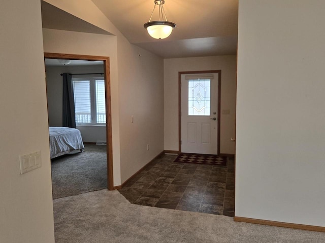 foyer entrance with carpet, baseboards, and a wealth of natural light