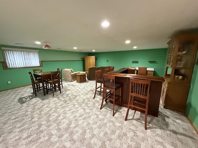 dining room with baseboards, a bar, carpet flooring, and recessed lighting