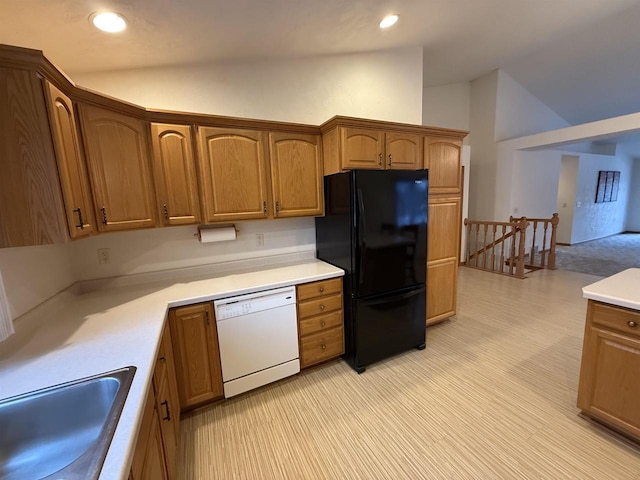 kitchen with freestanding refrigerator, light countertops, dishwasher, and lofted ceiling