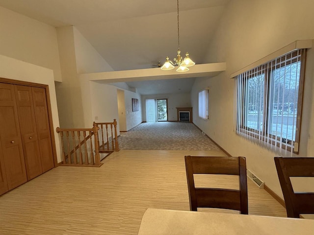 interior space featuring an inviting chandelier, an upstairs landing, wood finished floors, high vaulted ceiling, and baseboards