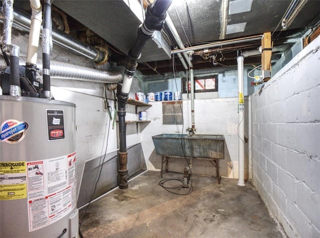 unfinished below grade area with a sink and gas water heater