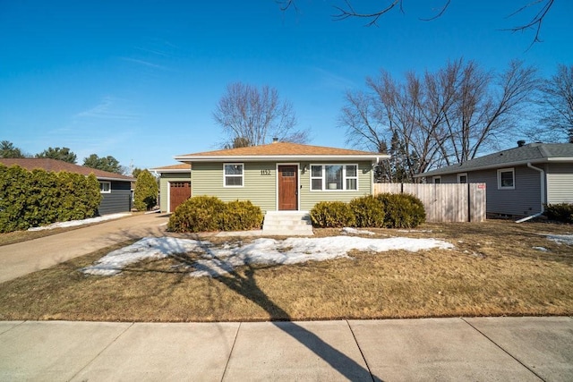 view of front of property with a garage, fence, and concrete driveway