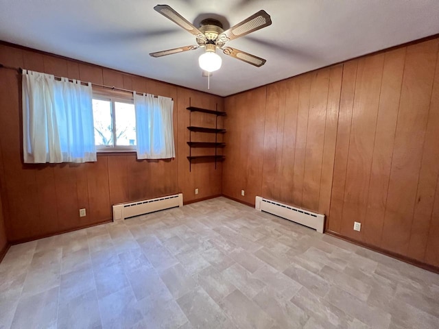 empty room featuring a baseboard radiator, ceiling fan, and wood walls