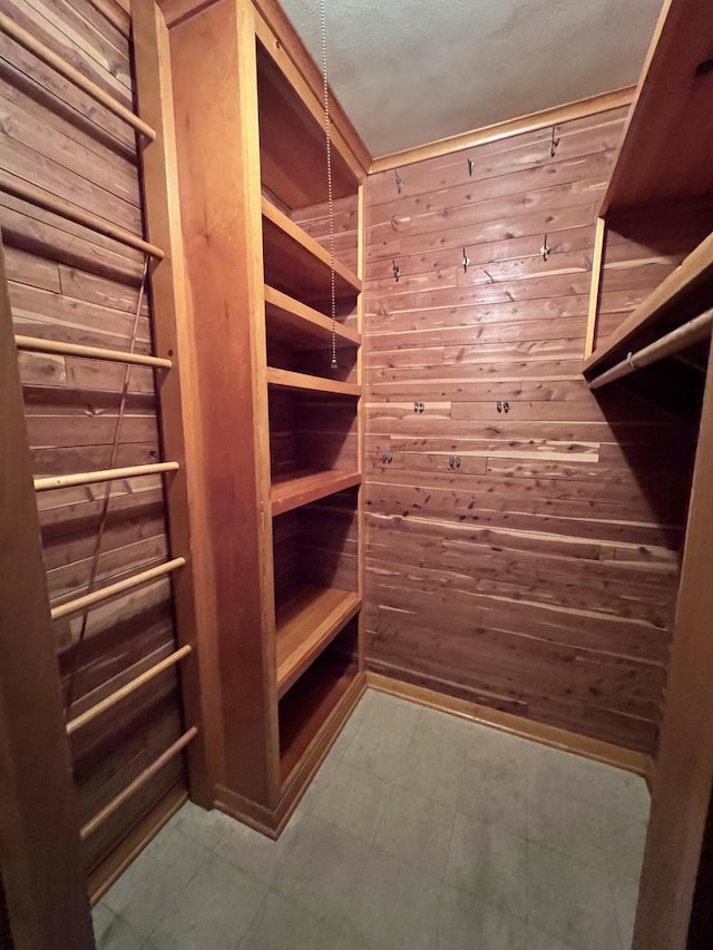 spacious closet with tile patterned floors