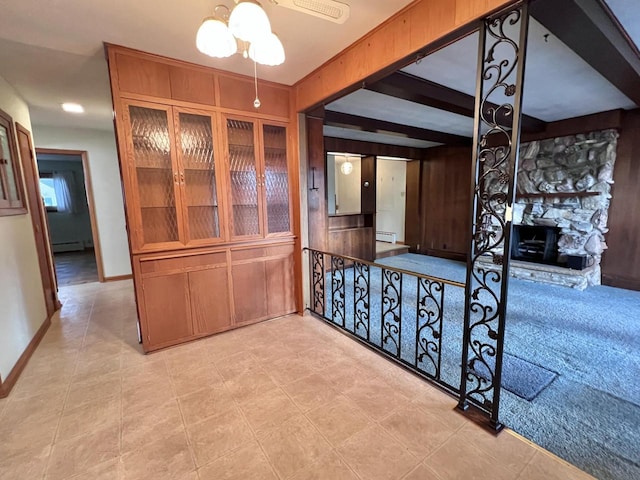 hall with baseboards, beamed ceiling, and baseboard heating