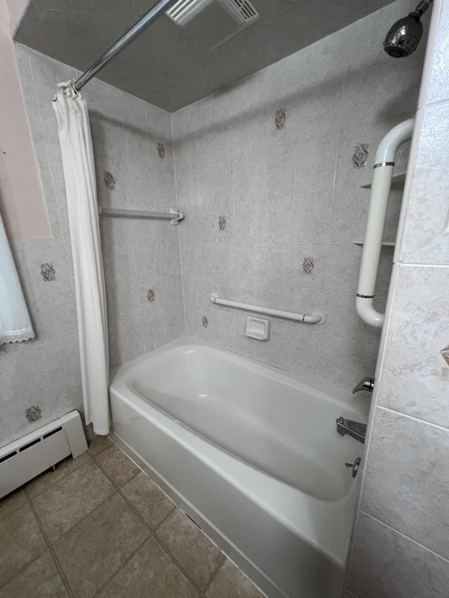 bathroom featuring baseboard heating, tile patterned flooring, shower / bath combination with curtain, and tile walls