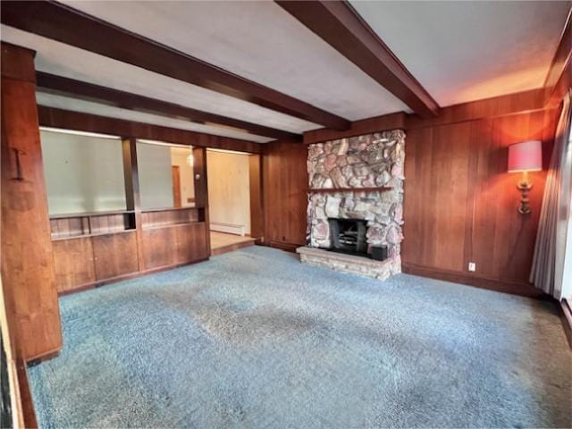 unfurnished living room featuring carpet floors, wood walls, and beam ceiling