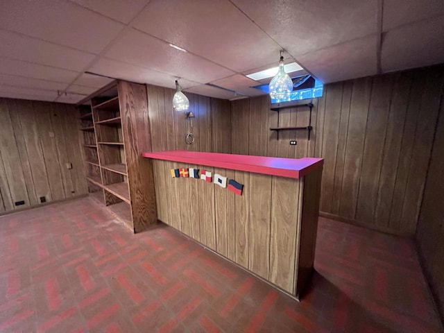 bar featuring a dry bar, wooden walls, and a paneled ceiling