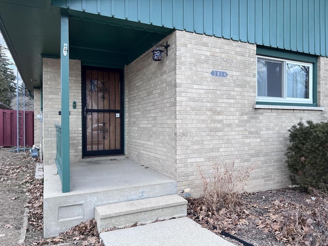 property entrance with brick siding